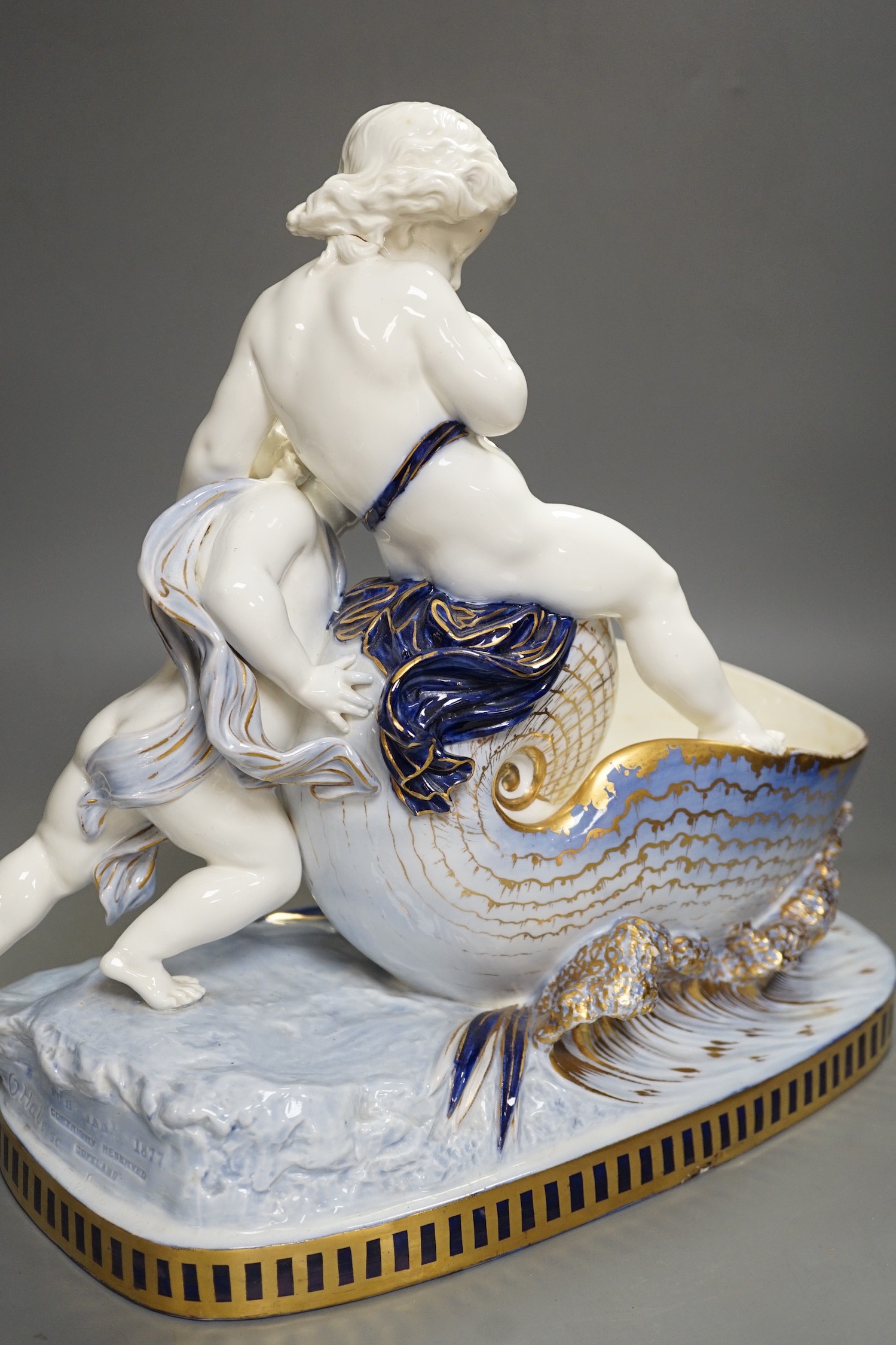 A Copeland porcelain putti seated on a shell centrepiece, modelled by O. Hale, c.1877, 35cms high